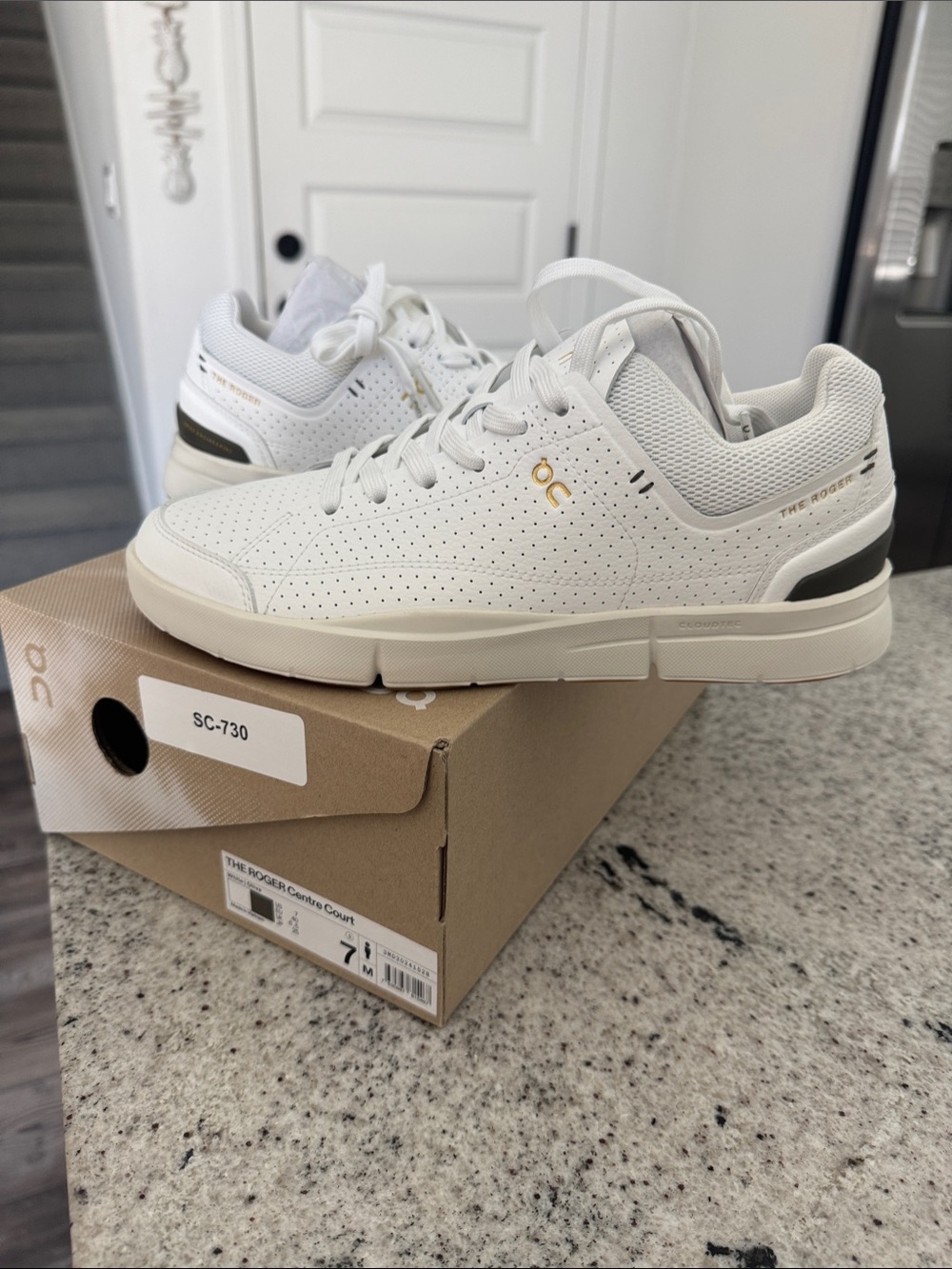 On Cloud Men's The Rodger Centre Court White Sneakers with Gold Accent